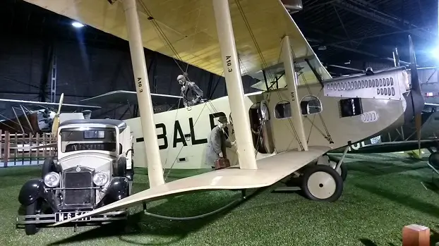 исторический пассажирский биплан De Havilland Dragon Rapide и старинный автомобиль в ангаре музея Кбелы